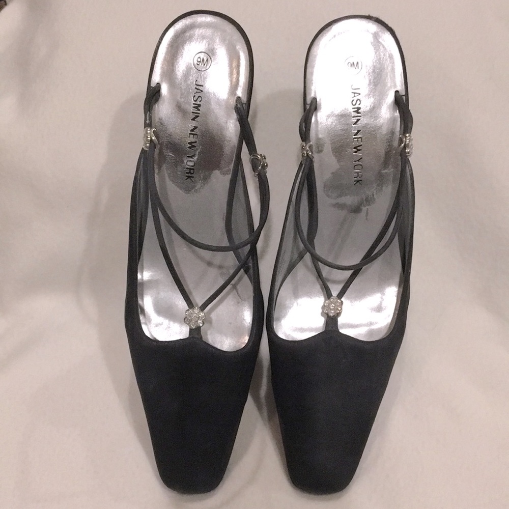 Black satin kitten heels with rhinestone embellishments.